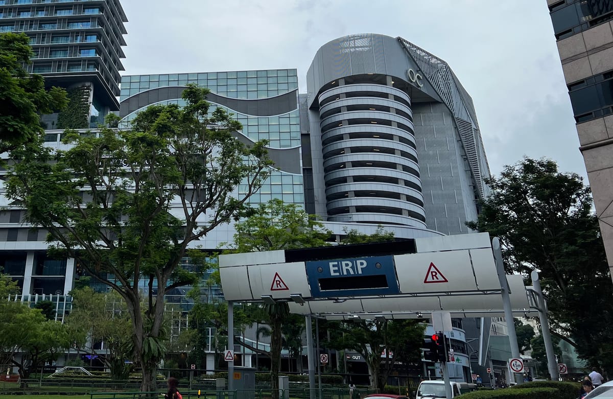 Electronic Road Pricing gantry on Killiney Road in Singapore, with buildings and trees behind it.