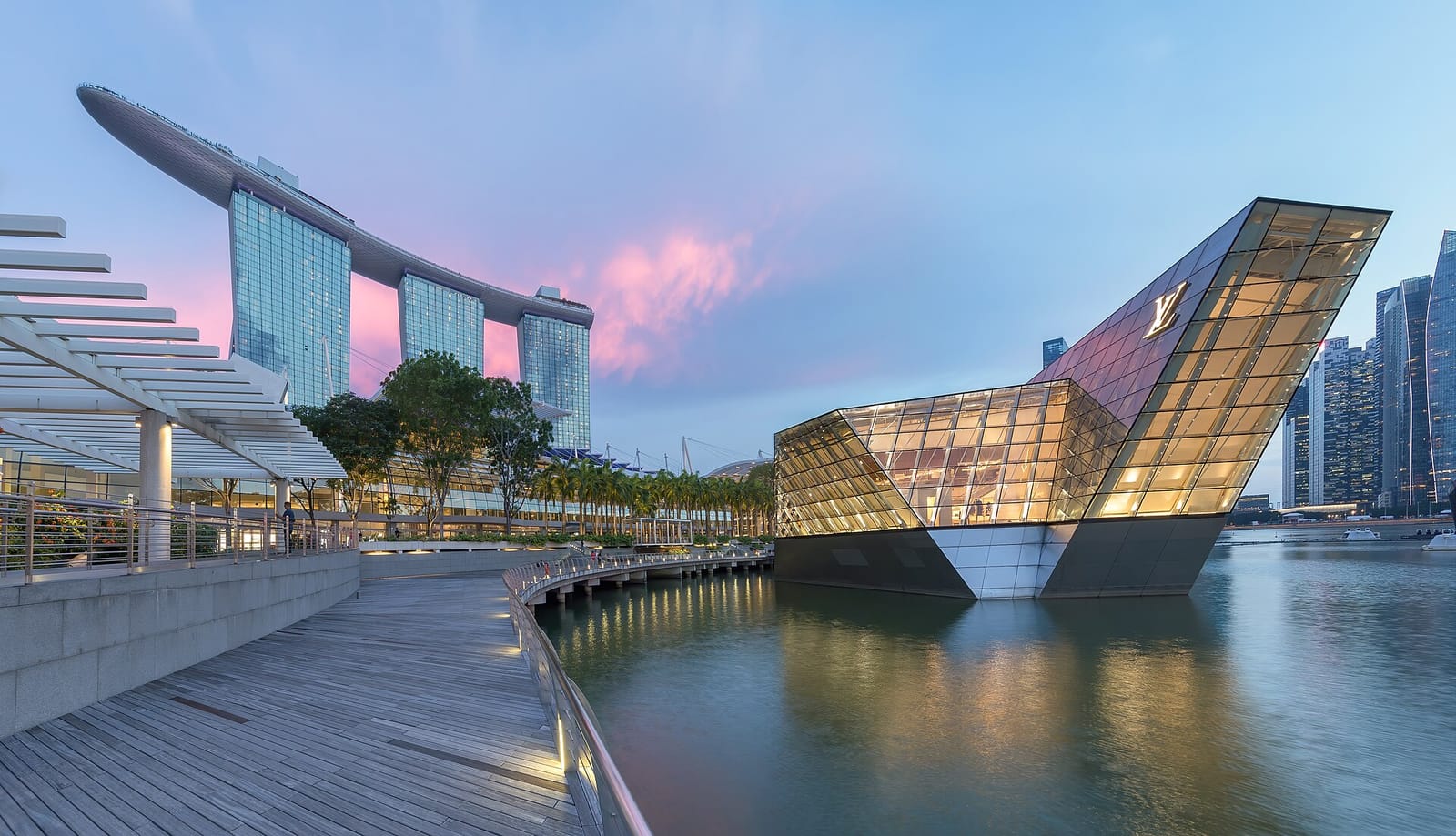 Marina Bay Sands hotel towers and the Louis Vuitton island pavilion on Marina Bay at blue hour in Singapore